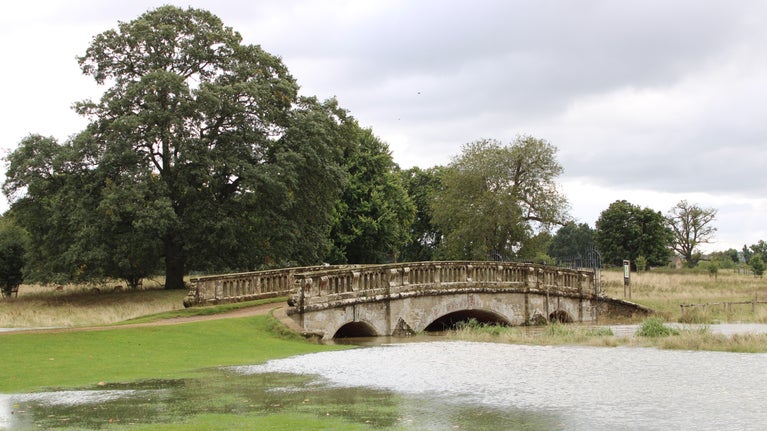 The River Dene burst its banks under the Slaughter Bridge at Charlecote Park, Warwickshire